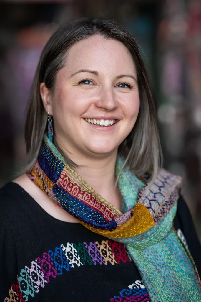 Georgie Sears, creative life coach, smiling in a colourful hand-stitched scarf